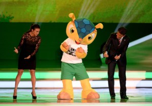 Fuleco dancing with hosts at the World Cup Draw in December 2013.