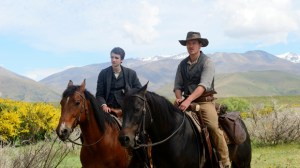 Slow West is of a bounty hunter, played by Michael Fassbender (right), helping a Scottish émigré, played by Kodi Smit-McPhee (left), reunite with the woman he loves.